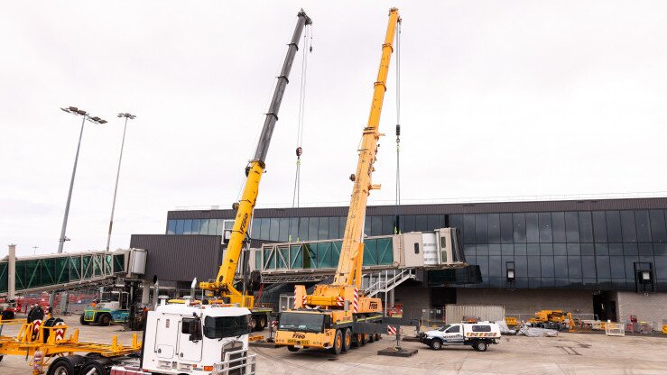 Dual crane lift installing aerobridge at Gold Coast Airport