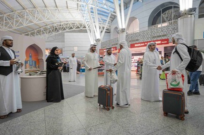 Returning Hajj pilgrims receive a warm welcome at Sharjah Airport with flowers and traditional Emirati hospitality